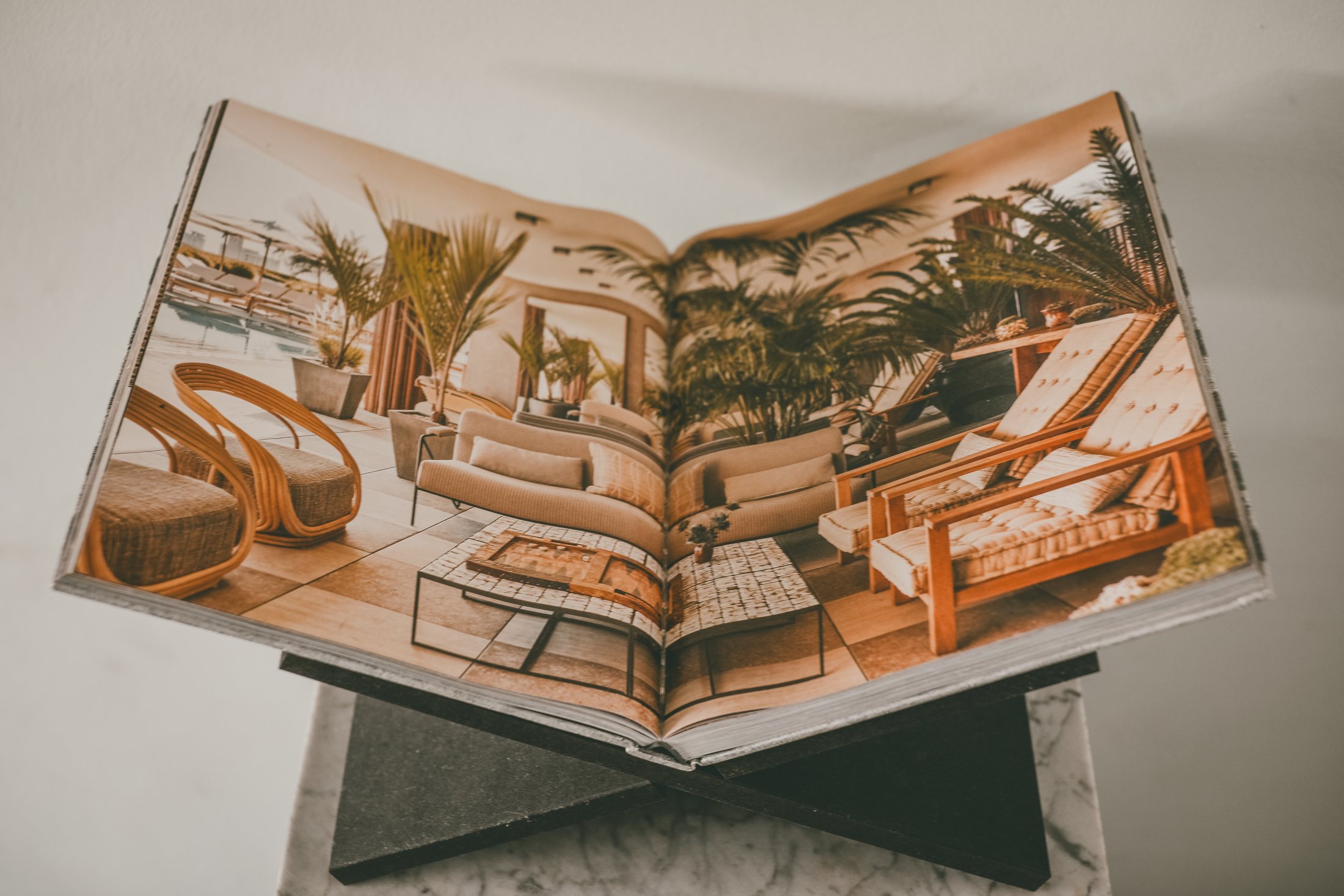 An interior design book open on a stand