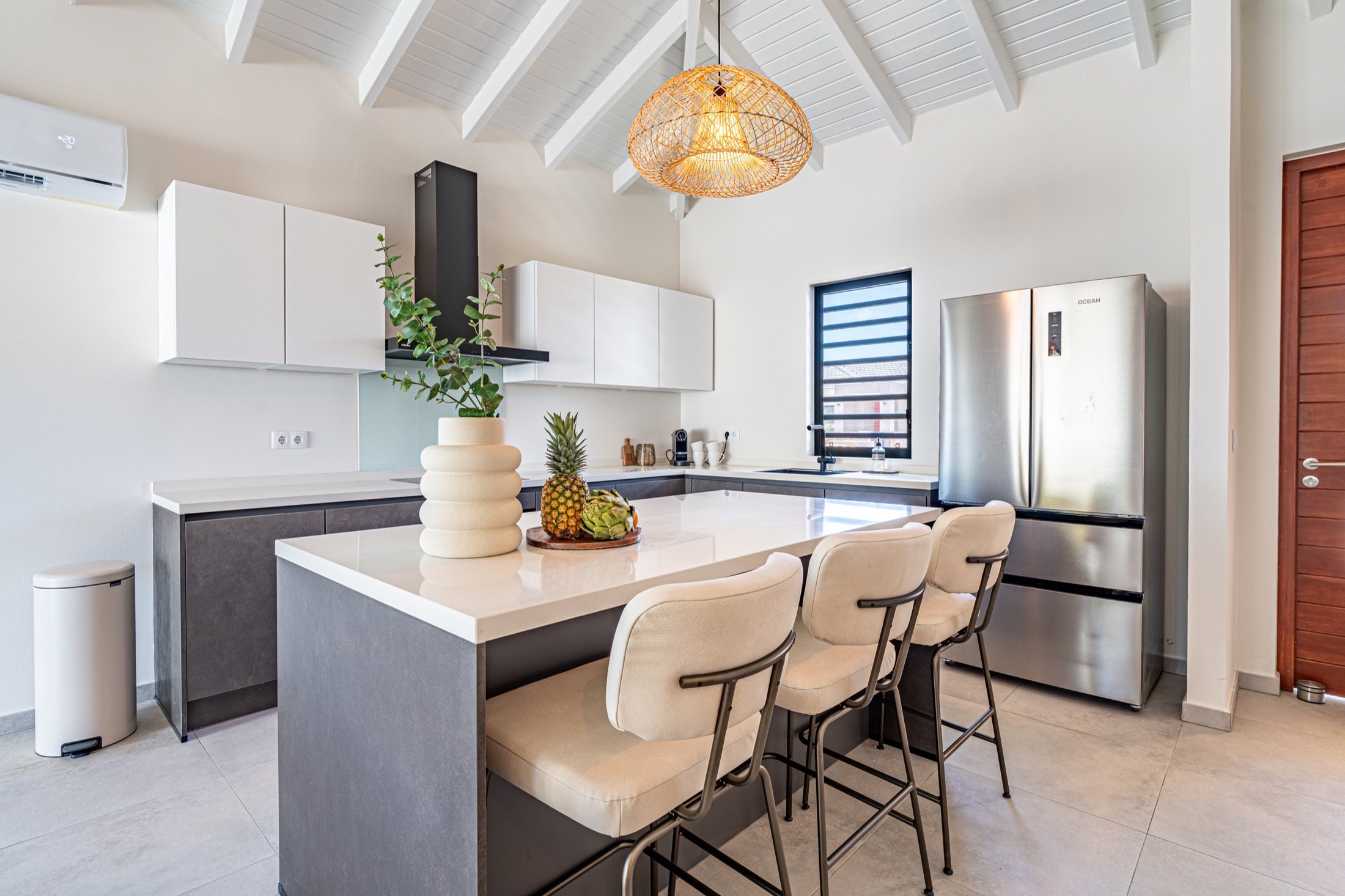 Kitchen island with woven pendant at Kaya Sirena