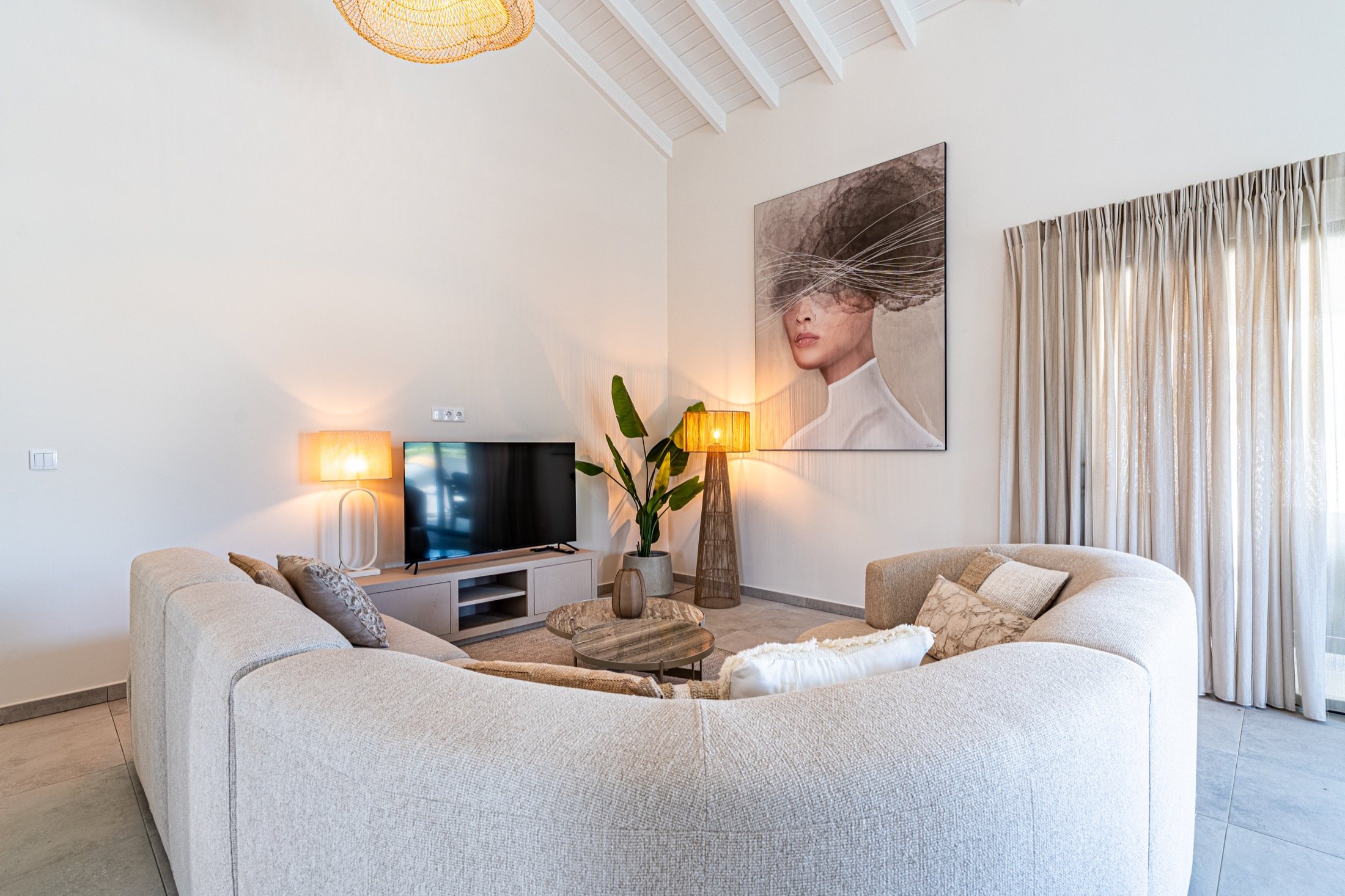 Living room with soft seating and artwork at Kaya Sirena