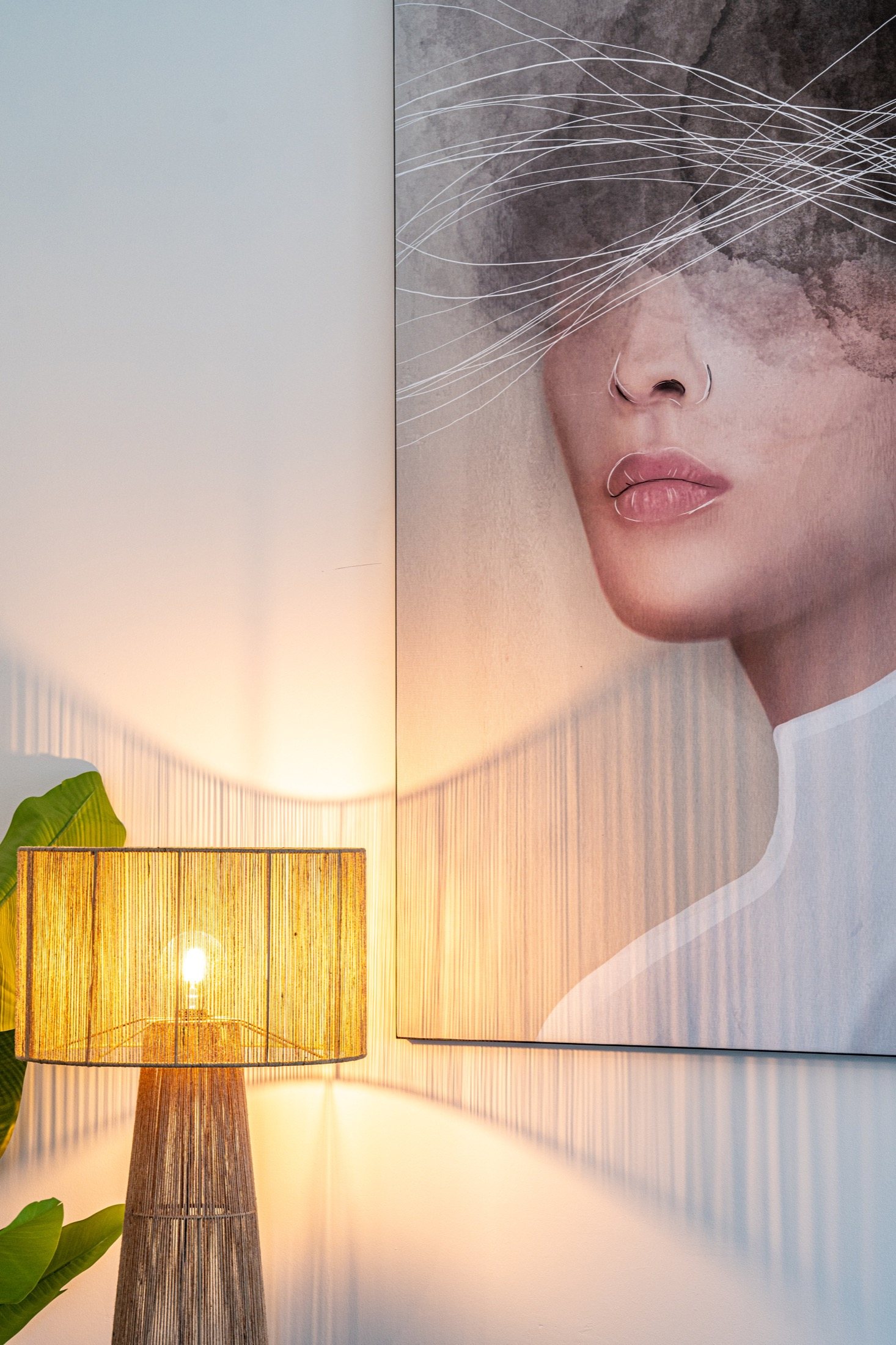 Warm lamp beside a large artwork